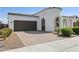 Charming stucco home featuring a turret entrance, tile roof, and a paved driveway, complete with desert landscaping at 22964 E Via Del Sol --, Queen Creek, AZ 85142
