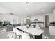 Contemporary open-concept living and dining area with modern decor, a kitchen island, and lots of natural light at 22964 E Via Del Sol --, Queen Creek, AZ 85142