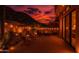 Cozy outdoor patio at dusk, complete with ambient lighting, comfortable seating, and scenic desert mountain views at 25555 N Windy Walk Dr # 69, Scottsdale, AZ 85255