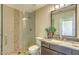 Modern bathroom with granite countertops, glass shower, decorative stone wall and upgraded fixtures at 25555 N Windy Walk Dr # 69, Scottsdale, AZ 85255