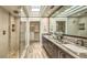 Modern bathroom with a large walk-in shower, double vanity, and spacious walk-in closet at 25555 N Windy Walk Dr # 69, Scottsdale, AZ 85255