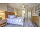 Stylish bedroom featuring modern decor, wood flooring, and a comfortable king-size bed with decorative pillows at 25555 N Windy Walk Dr # 69, Scottsdale, AZ 85255