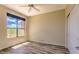 This bedroom has neutral walls, a ceiling fan, wide window with a beautiful view and wood-look floors at 25555 N Windy Walk Dr # 69, Scottsdale, AZ 85255