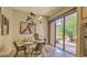 Dining area featuring a modern chandelier, round table set, and glass doors to outdoor patio at 25555 N Windy Walk Dr # 69, Scottsdale, AZ 85255
