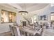 Bright dining room with modern decor, stone floors, and open view to the living room at 25555 N Windy Walk Dr # 69, Scottsdale, AZ 85255