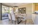 This dining room is featuring stone floors, modern light fixtures, and sliding glass doors to the patio at 25555 N Windy Walk Dr # 69, Scottsdale, AZ 85255