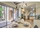 Bright dining area featuring stone floors, modern light fixtures, and a view into the kitchen at 25555 N Windy Walk Dr # 69, Scottsdale, AZ 85255