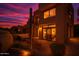 Exterior view of a desert modern home featuring a patio, desert landscaping and evening sunset at 25555 N Windy Walk Dr # 69, Scottsdale, AZ 85255