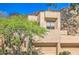 Attractive townhome exterior with desert landscaping, mature trees, and attached two car garage at 25555 N Windy Walk Dr # 69, Scottsdale, AZ 85255