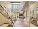 Inviting foyer with flagstone floors, wrought iron staircase, high ceilings and views to the backyard at 25555 N Windy Walk Dr # 69, Scottsdale, AZ 85255