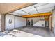 Organized garage space with custom storage, EV charger, and staircase at 25555 N Windy Walk Dr # 69, Scottsdale, AZ 85255