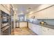 Bright kitchen featuring stainless steel appliances, white cabinets, and gray subway tile backsplash at 25555 N Windy Walk Dr # 69, Scottsdale, AZ 85255