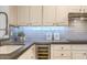 Close-up of kitchen with white cabinets, gray countertops, and stylish subway tile at 25555 N Windy Walk Dr # 69, Scottsdale, AZ 85255