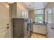 Convenient laundry room with front-loading washer and dryer, built-in cabinets, and a utility sink at 25555 N Windy Walk Dr # 69, Scottsdale, AZ 85255