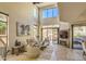 Bright living room featuring stone floors, a fireplace, and sliding glass doors to a relaxing patio at 25555 N Windy Walk Dr # 69, Scottsdale, AZ 85255