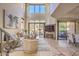Bright living room featuring stone floors, a fireplace, and sliding glass doors to a relaxing patio at 25555 N Windy Walk Dr # 69, Scottsdale, AZ 85255