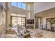 Bright living room featuring stone floors, a fireplace, and sliding glass doors to a relaxing patio at 25555 N Windy Walk Dr # 69, Scottsdale, AZ 85255