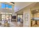 Bright living room featuring a fireplace, and sliding glass doors to the patio with scenic views at 25555 N Windy Walk Dr # 69, Scottsdale, AZ 85255