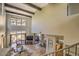 Bright and open concept living room with fireplace, stone floors, and large windows showcasing the view at 25555 N Windy Walk Dr # 69, Scottsdale, AZ 85255