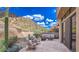Inviting flagstone patio features stylish seating and stunning desert mountain views at 25555 N Windy Walk Dr # 69, Scottsdale, AZ 85255