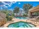 Resort-style community pool area with a waterfall feature and a relaxing hot tub at 25555 N Windy Walk Dr # 69, Scottsdale, AZ 85255