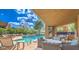 Community pool area featuring an outdoor seating area with lounge chairs and tables at 25555 N Windy Walk Dr # 69, Scottsdale, AZ 85255