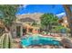 Community pool featuring lush landscaping, desert rock formations, and lounge chairs at 25555 N Windy Walk Dr # 69, Scottsdale, AZ 85255