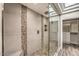 Walk-in shower with elegant tile work, glass doors, and built-in shelving at 25555 N Windy Walk Dr # 69, Scottsdale, AZ 85255