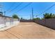 Spacious backyard with a block fence, and featuring a building with metal-grate windows and doors at 2721 W Luke Ave, Phoenix, AZ 85017