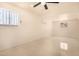 A bedroom with ceiling fan, air conditioner and white tile floors at 2721 W Luke Ave, Phoenix, AZ 85017