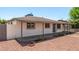 Single-story home with covered patio, minimal landscaping, and white painted brick at 2721 W Luke Ave, Phoenix, AZ 85017