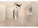 Bright living room with modern tile flooring, ceiling fan, and ample space at 2721 W Luke Ave, Phoenix, AZ 85017