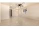Bright living room with modern tile flooring, ceiling fan, and chandelier at 2721 W Luke Ave, Phoenix, AZ 85017