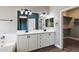 Bathroom features dual sinks, lots of cabinetry, and a door to a walk-in closet at 2761 W Via Calabria --, Phoenix, AZ 85086