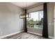 Dining area with modern light fixture and a view of the pool and backyard at 2761 W Via Calabria --, Phoenix, AZ 85086