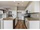 Modern kitchen with white cabinets, granite countertops, wood floors, and stainless steel appliances at 2761 W Via Calabria --, Phoenix, AZ 85086