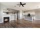 Open-concept living space features a fireplace and flows into a kitchen with white cabinets and granite countertops at 2761 W Via Calabria --, Phoenix, AZ 85086