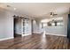 Open living space featuring wood floors, modern lighting, and a barn door at 2761 W Via Calabria --, Phoenix, AZ 85086