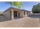 View of the covered patio and low-maintenance rock landscaping in the backyard at 29356 N 67Th Ave, Peoria, AZ 85383
