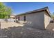 Low-maintenance backyard featuring rock landscaping and privacy wall at 29356 N 67Th Ave, Peoria, AZ 85383