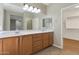Spacious bathroom with double vanity, updated fixtures, large mirror and ceramic tile flooring at 29356 N 67Th Ave, Peoria, AZ 85383