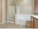 Modern bathroom featuring a separate shower and tub, with tile flooring and a bright, airy atmosphere at 29356 N 67Th Ave, Peoria, AZ 85383