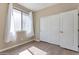 Bright bedroom features wood-look floors, neutral paint, and a sliding door closet at 29356 N 67Th Ave, Peoria, AZ 85383
