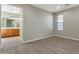 Cozy bedroom with laminate floors leading to an ensuite bathroom with a large vanity and ample counter space at 29356 N 67Th Ave, Peoria, AZ 85383