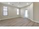 Bright bedroom features light-colored laminate flooring, neutral paint, and a ceiling fan for comfortable living at 29356 N 67Th Ave, Peoria, AZ 85383