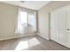 Bright bedroom features wood-look floors, neutral paint, and a window with sheer curtains at 29356 N 67Th Ave, Peoria, AZ 85383