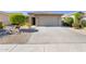 Well-maintained garage with concrete driveway, desert landscaping and a tidy exterior offering practical suburban living at 29356 N 67Th Ave, Peoria, AZ 85383
