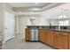 Kitchen area with stainless steel dishwasher and granite countertops, seamlessly integrates with the home's design at 29356 N 67Th Ave, Peoria, AZ 85383