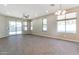 Bright living room with tile flooring, large sliding glass doors, and multiple windows for plenty of natural light at 29356 N 67Th Ave, Peoria, AZ 85383