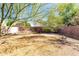 Spacious backyard with mature tree, perfect for outdoor activities and relaxation, surrounded by block fence for privacy at 3049 W Santa Cruz Ave, San Tan Valley, AZ 85144